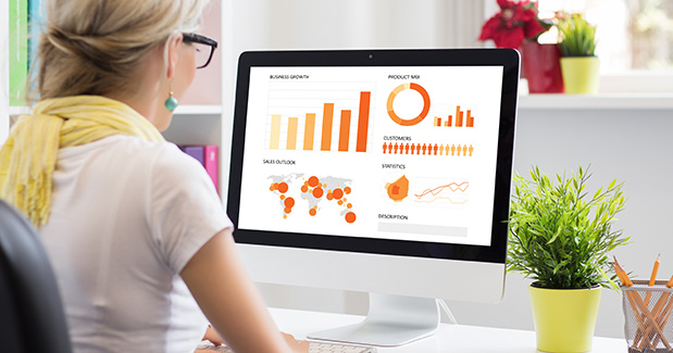 business woman analyzing customer data on desktop computer